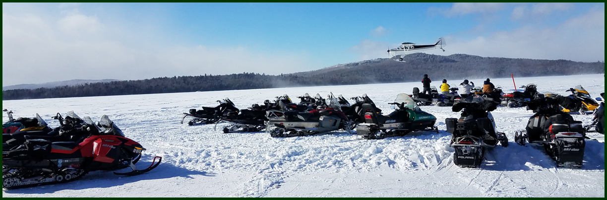 picture of BMC overlooking lake and snowmobiles in winter